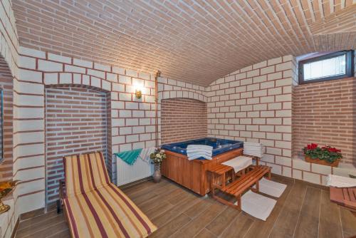 a room with a jacuzzi in a brick wall at Enderun Hotel Istanbul in Istanbul