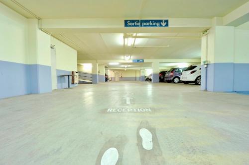 a large empty parking garage with cars parked in it at Holiday Inn Lyon Vaise by IHG in Tassin-la-Demi-Lune