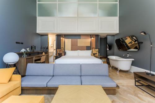 a living room with a bed and a couch at Room Mate Emir, Istanbul in Istanbul