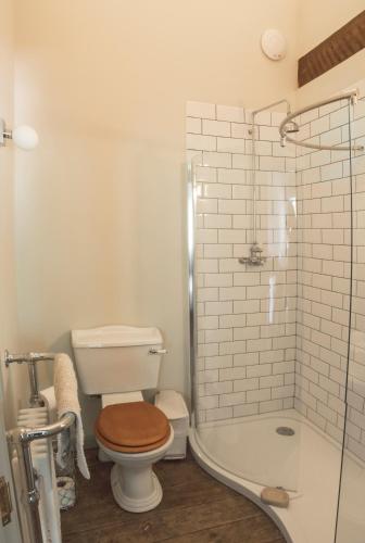 a bathroom with a toilet and a shower at Tailor Room 3 in Lincoln