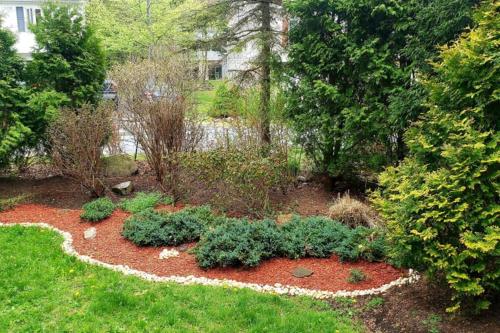 a garden with flowers and plants in a yard at Paradise in heart of Poconos FaSt InTeRnEt Close to All Attractions in Pocono Summit