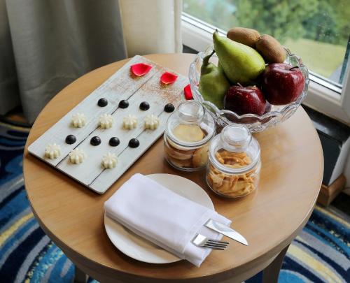 a table with a bowl of fruit and a bowl of food at Welcomhotel by ITC Hotels, Shimla in Shimla