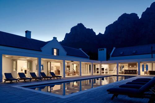 
a hotel room with a lot of windows overlooking the ocean at Boschendal Farm Estate in Franschhoek
