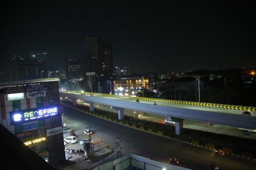 a city street at night with a highway at Hotel Skyview Suites & Studios in Hyderabad