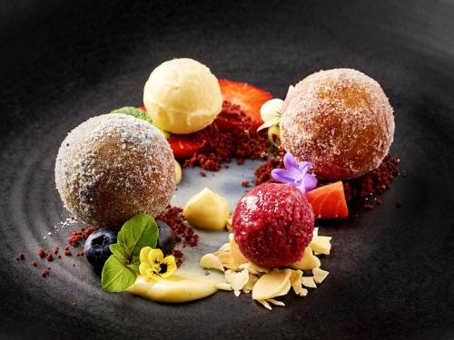 a plate of food with desserts on it at Salnerhof Superior Lifestyle Resort in Ischgl