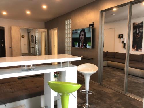 a living room with a couch and a tv on the wall at Luxury Westpark 2 Residence Lake View W6 in Bucharest
