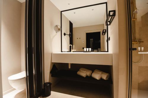 a bathroom with a sink and a mirror at Hotel Sanglier in Durbuy
