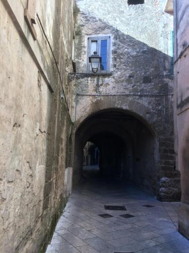 an alley in a stone building with a window at B&b Sant'Agata in SantʼAgata deʼ Goti