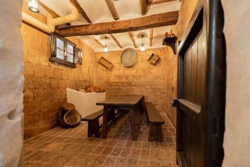 a bathroom with a wooden table and a table at LAGAR DEL PALOMAR in Teruel