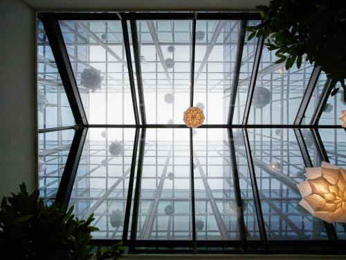 a glass window in a building with a ceiling at citizenM Tower of London in London