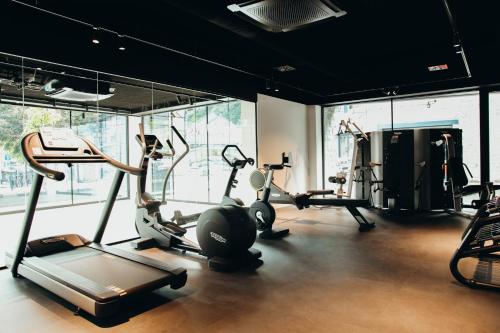 a gym with several treadmills and exercise bikes at Hotel Sanglier in Durbuy