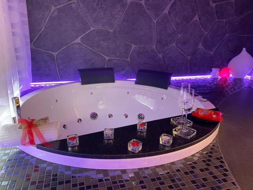 a bath tub with wine glasses in a room at TH LUXURY fly in Catania