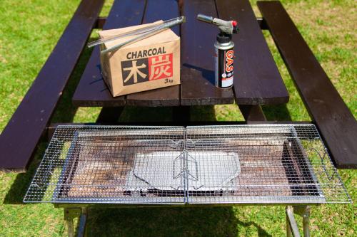a table with a bird cage and a box on it at Villa Itona ishigakijima in Ishigaki Island