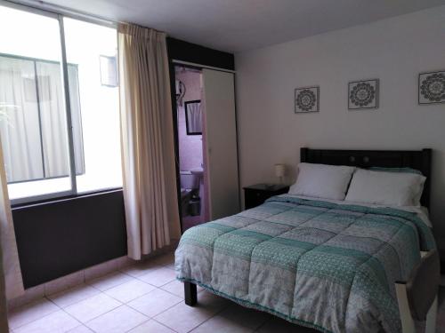 a bedroom with a bed and a large window at Hospedaje de Lidia in Lima
