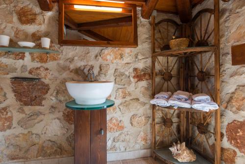 a bathroom with a sink on a wooden stand at Luxury Zakynthos Villa Harron Villa 4 Bed Private Pool Agios Nikolaos in Zakynthos
