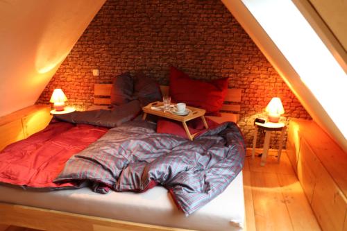 a bed in a room with a brick wall at Maisonette Pablo in Gummersbach