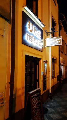 a sign for a restaurant on the side of a building at Hotel U koně in Beroun