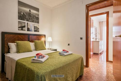 a bedroom with a large bed with towels on it at Alcam Barbera Centro in Barbera del Valles