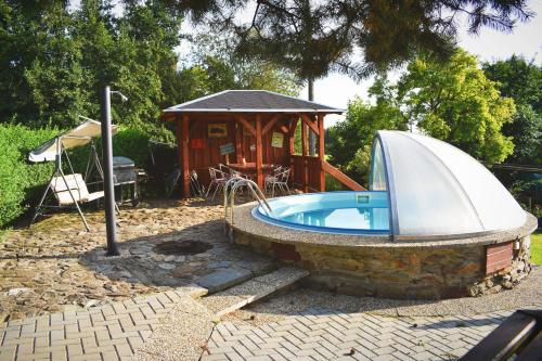 a hot tub and a gazebo in a yard at Pension Ivanka in Jestrabi V Krkonosich