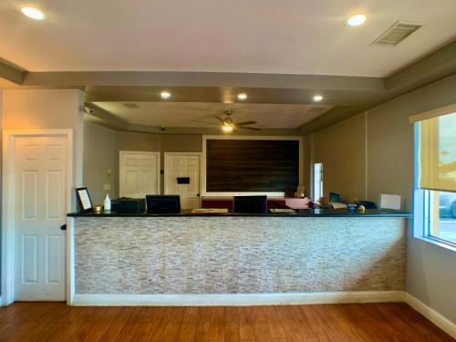 a lobby with a bar with a projection screen at LA VISTA INN in Port Richey