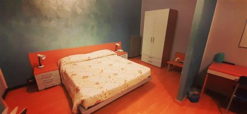 a small bedroom with a bed and a dresser at Hotel Ristorante Cibarium in Gualdo Tadino