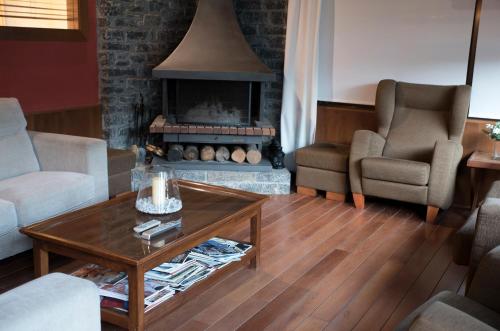 a living room with a couch and a fireplace at Hotel Florido in Sort