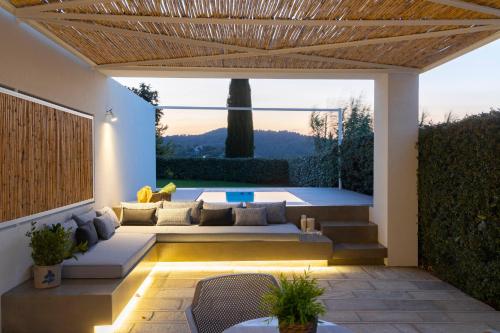 a patio with a couch and a table at Atrium Hotel in Agia Paraskevi