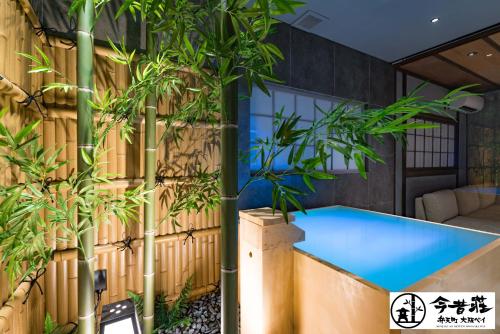 a swimming pool in a house with bamboo plants at Konjaku-So Bentencho Osaka Bay -Universal Bay Area- in Osaka