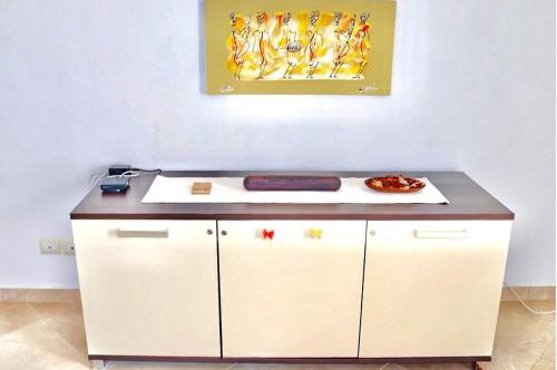 a counter with a plate of food on top of it at Comfortable and spacious apartment with ocean views of Cabral beach in Sal Rei