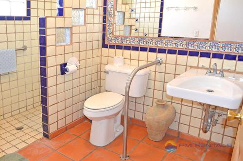 a bathroom with a toilet and a sink at Casa Las Vistas del Mar by FMI Rentals in Puerto Peñasco