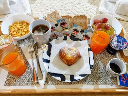 a breakfast tray with a heart shaped pastry and drinks at DUOMO 152 NAPOLI in Naples