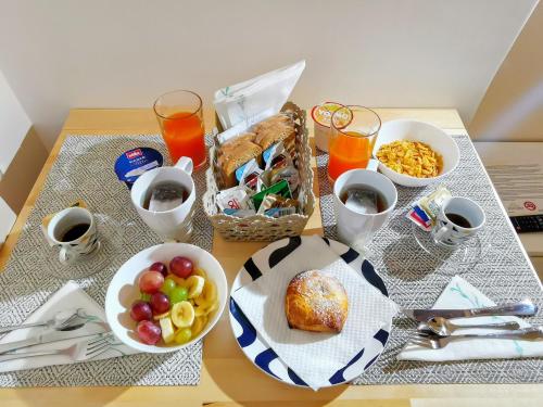 a table topped with bowls of food and a basket of food at DUOMO 152 NAPOLI in Naples