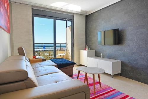 a living room with a couch and a tv at Penthouse with Panoramic View by NRAS in Santa Pola