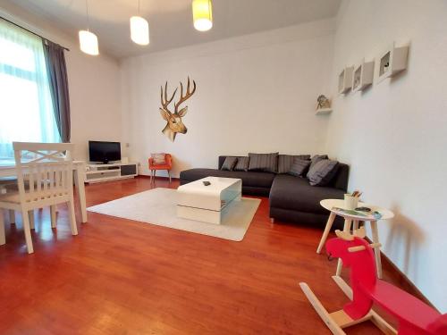 a living room with a couch and a table at Deák Apartman in Sopron