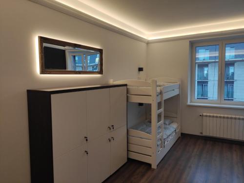 a room with a bunk bed and a mirror at Greg&Tom Hostel in Kraków