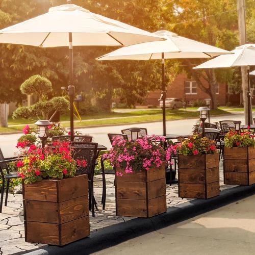 a group of tables with flowers and umbrellas at Centerstone Plaza Hotel Soldiers Field - Mayo Clinic Area in Rochester