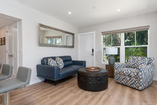 a living room with a blue couch and a chair at Escape Coastal Resort on Casey Key in Nokomis