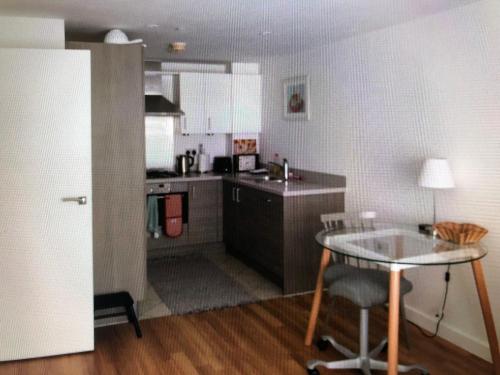 a small kitchen with a table and a counter top at Kingston Flat in Kingston upon Thames