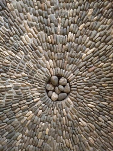 a close up of a piece of wood with pebbles on it at Posada Nuuna Mazunte in Mazunte