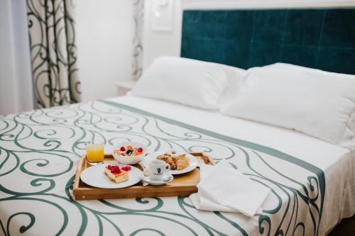 a tray of breakfast food on a bed at HOTEL CITTA' DI PARENZO in Trieste