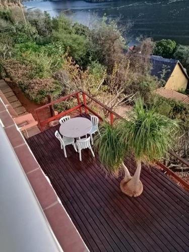 a patio with a table and chairs on a deck at Letamong in Hartbeespoort