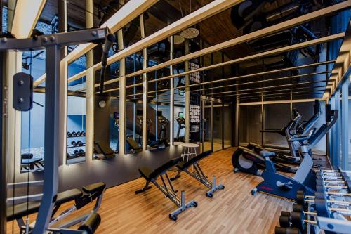 a gym with cardio equipment in a building at Centara Q Resort Rayong in Mae Pim