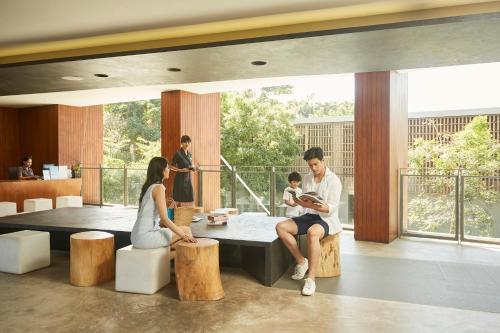 a group of people sitting around a table in a building at Centara Q Resort Rayong in Mae Pim
