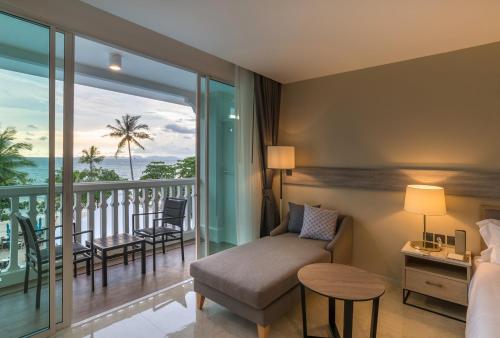a hotel room with a bed and a balcony at Centara Ao Nang Beach Resort & Spa Krabi in Ao Nang Beach