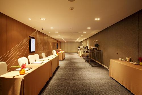 a row of tables and chairs in a room at Centara Watergate Pavilion Hotel Bangkok in Bangkok