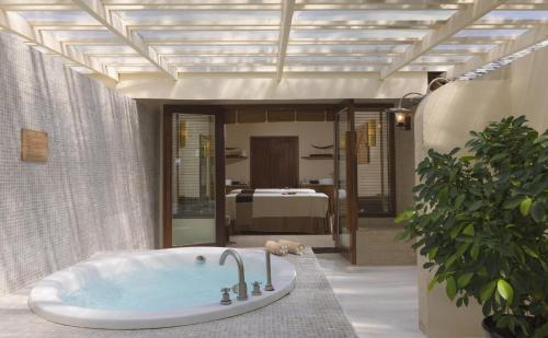 a bath tub sitting in the middle of a room at Centara Ras Fushi Resort & Spa Maldives - 50 percent discount on transfers for min 4 nights stay and more, valid for reservations between 11th Feb till 22 Dec 2025 in North Male Atoll