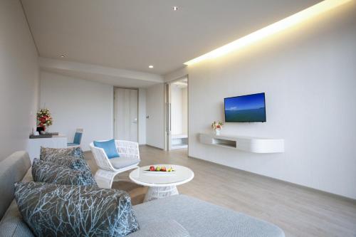 a living room filled with furniture and a tv at Centra by Centara Maris Resort Jomtien - SHA Extra Plus in Jomtien Beach