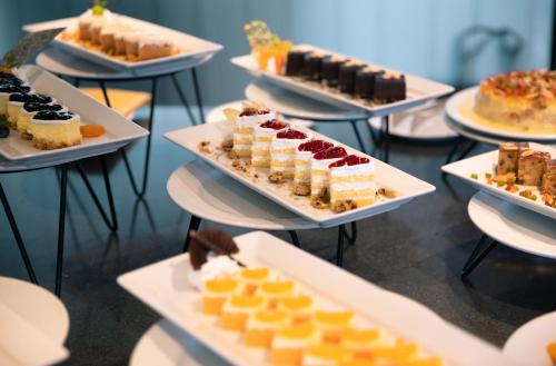 a display of different types of desserts on plates at Centara Life Government Complex Hotel & Convention Centre Chaeng Watthana in Bangkok