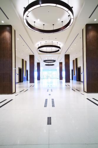 a large hall with a white floor and a large chandelier at Centara Life Government Complex Hotel & Convention Centre Chaeng Watthana in Bangkok