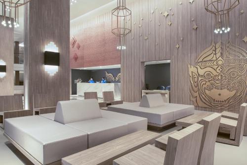 a room with two white couches and a table at Centara Life Phu Pano Krabi-SHA Plus in Ao Nang Beach
